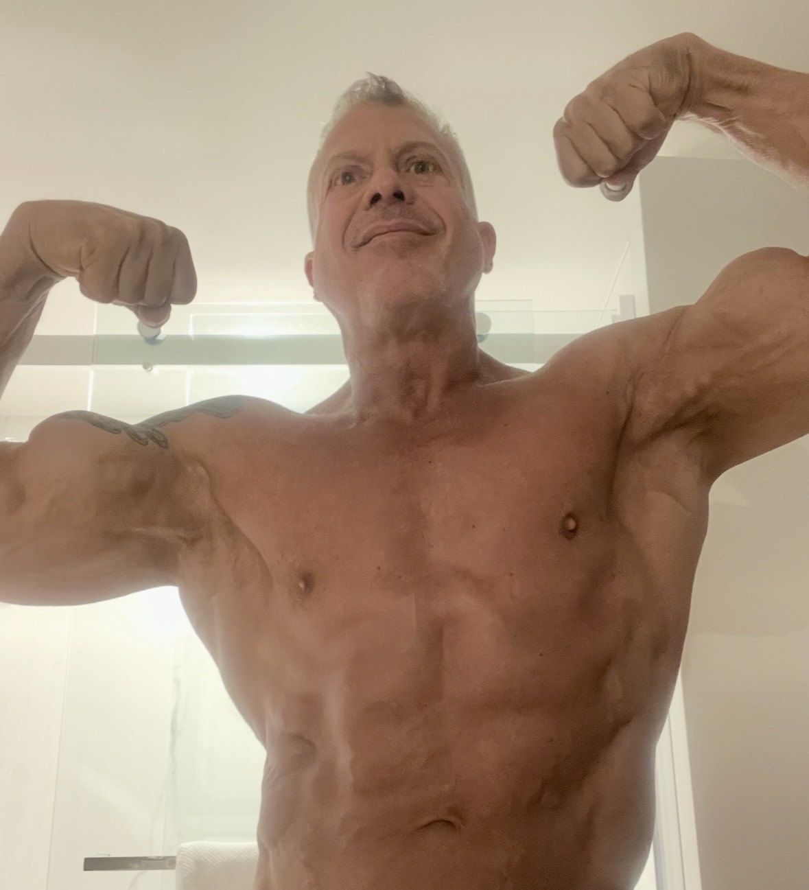 Dr. Cabrera flexing biceps and shoulders showing consistent results